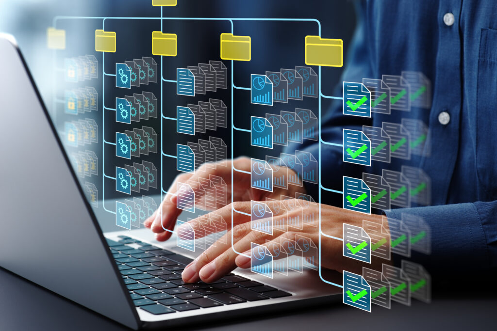 Document management system DMS Folder structure and classification system File and folder icons Businessman using laptop computer for controlling document versions - Semicon.TODAY