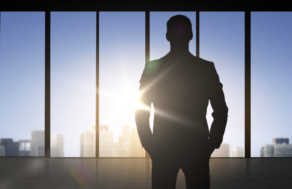 silhouette of business man over office background - Semicon.TODAY