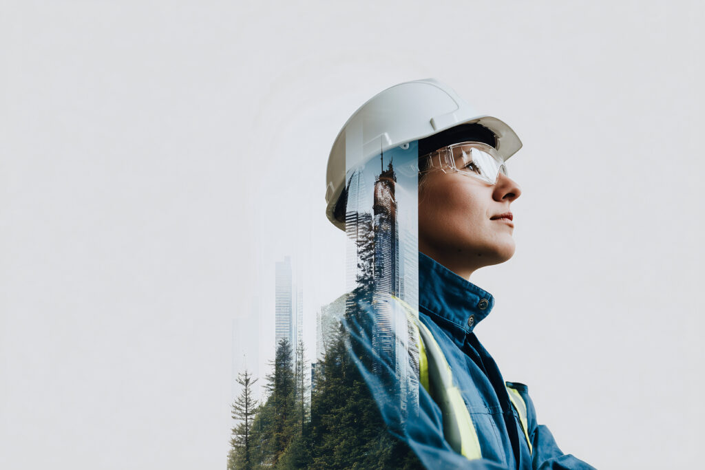 A female engineer wearing a safety helmet and looking up at the sky Her look shows a vision of the future or thinking about an idea - Semicon.TODAY