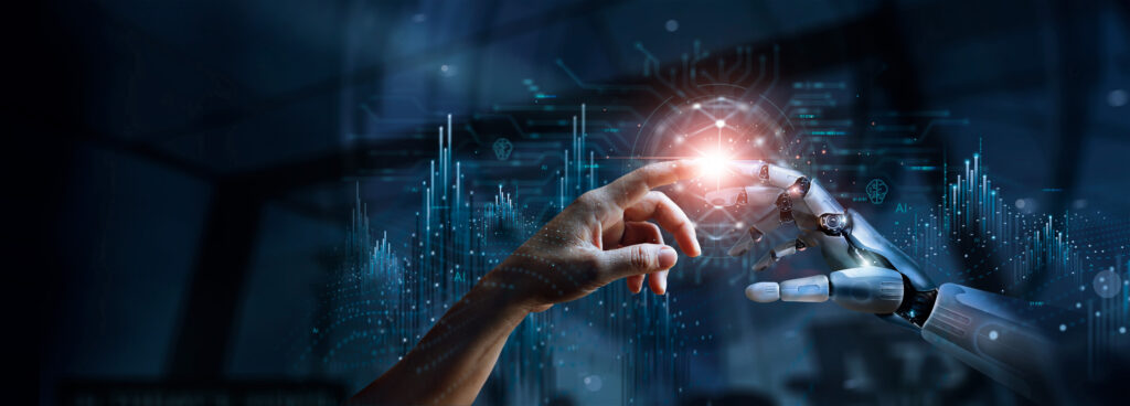 Human hand and robotic hand touch fingertips, glowing light between them, symbolizing human–AI collaboration in tech.