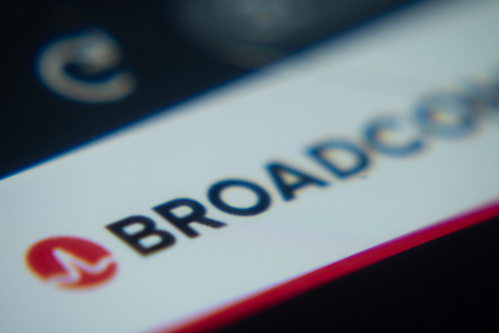 Dhaka Bangladesh- 02 Dec 2025 A Close-up of a laptop screen is displaying the Broadcom web interface in a browser - SEMICON.TODAY Blurred close-up of a smartphone screen showing a web browser app with a red circular icon on the left and faint text reading 'Browser' or similar.